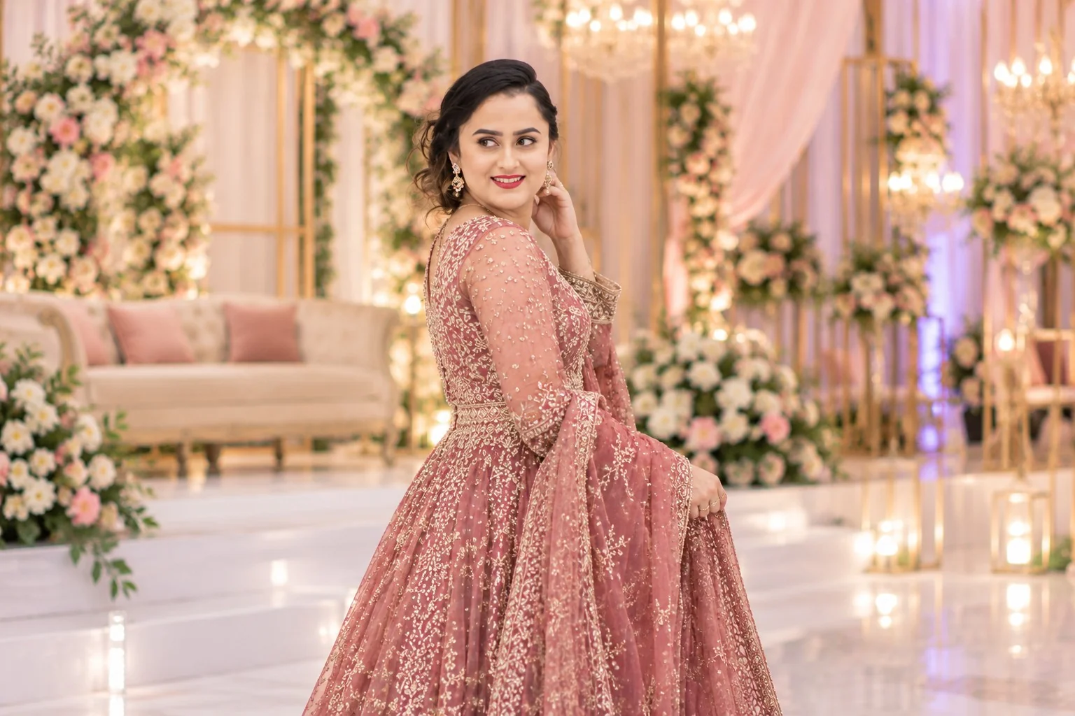 Woman in rose embroidered formal attire at a floral wedding venue